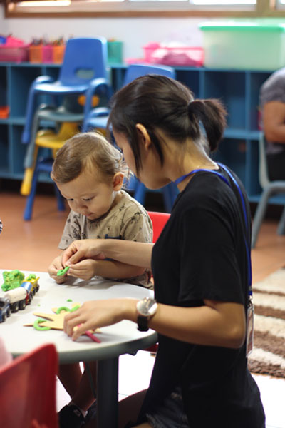 Early Years pupil and teacher in the classroom at CCS